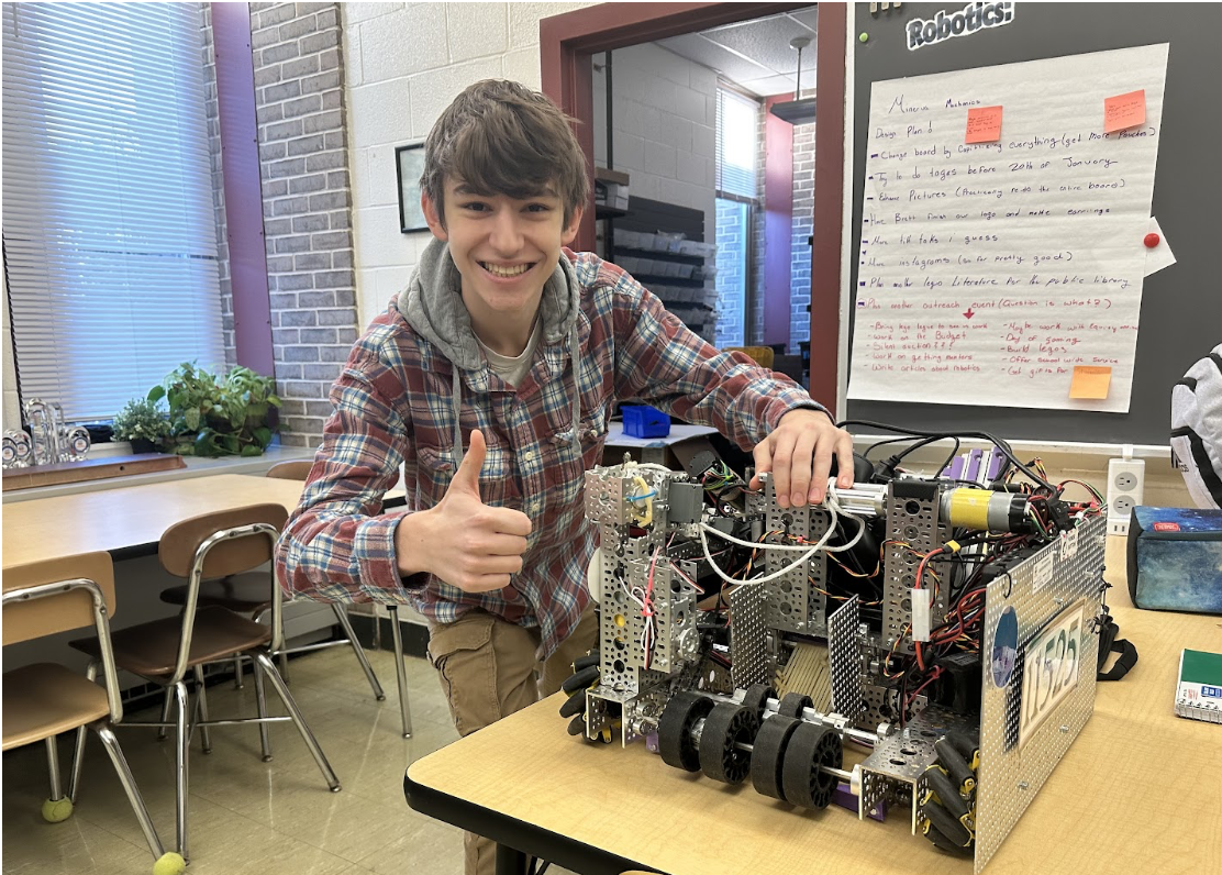 BHS senior, Michaeal, and a robot he built.